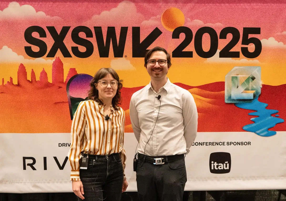 Fox and Martelaro stand side by side in front of SXSW signage