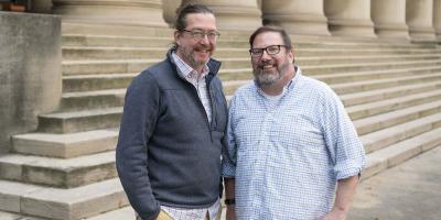 Bier and Stamper stand side by side on the steps outside of the Mellon Institute building