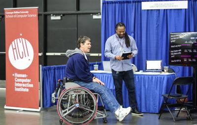 Patrick Carrington speaks with an athlete at the NWBT about SpokeSense