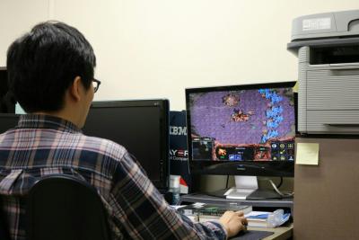 A researcher plays StarCraft against an AI player. A researcher plays StarCraft against an AI player.