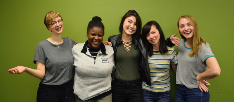 the 5 team members of the MedRespond team stand side by side in front of the MHCI green wall