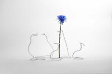Five 1D linear forms were morphed into 3D line sculptures once triggered with heat. One curls up to hold a blue flower