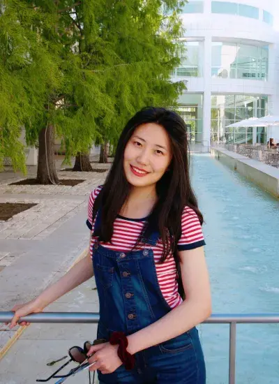 Photo of PhD Student Christina Ma in front of water fountain on CMU's campus