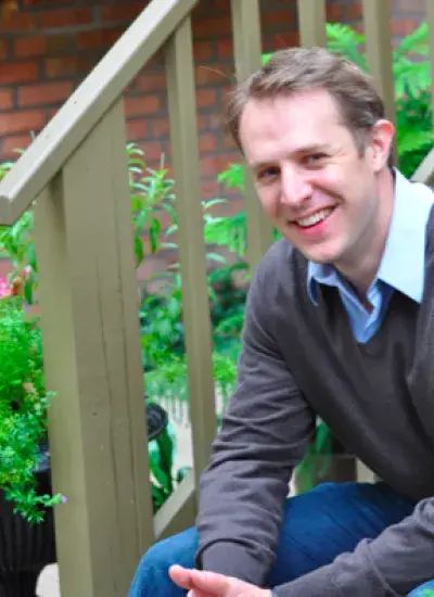 Steven Dow seated on steps outdoors