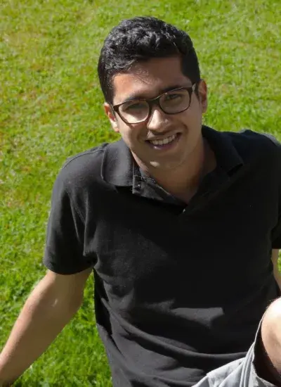 Photo of Saiganesh Swaminathan sitting on grass