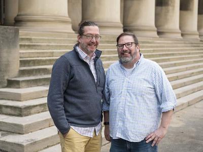 Norman Bier and John Stamper stand on the concrete steps in front of the CMU Mellon College of Science building