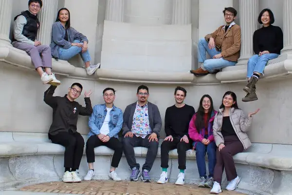 Several PhD students in the Coala Lab sit outside on Fine Arts building