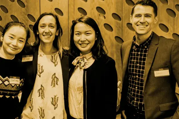 four team members of the Bloomberg student team in sepia tone photo