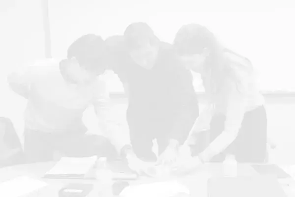 3 members of the team around a table doing visioning exercise