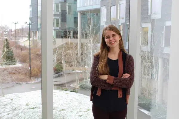 Stephanie Valencia, first year HCII PhD student, stands in the bridge to Gates