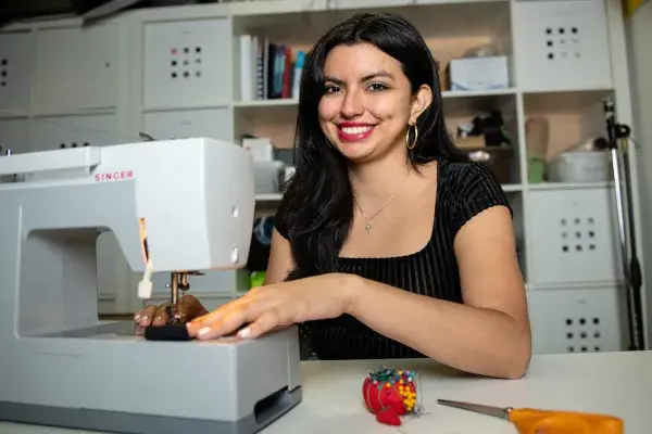 Ashley Burbano uses a sewing machine in the lab