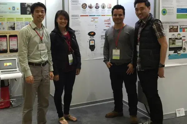 MHCI students standing in front of their Lantern poster at CHI.